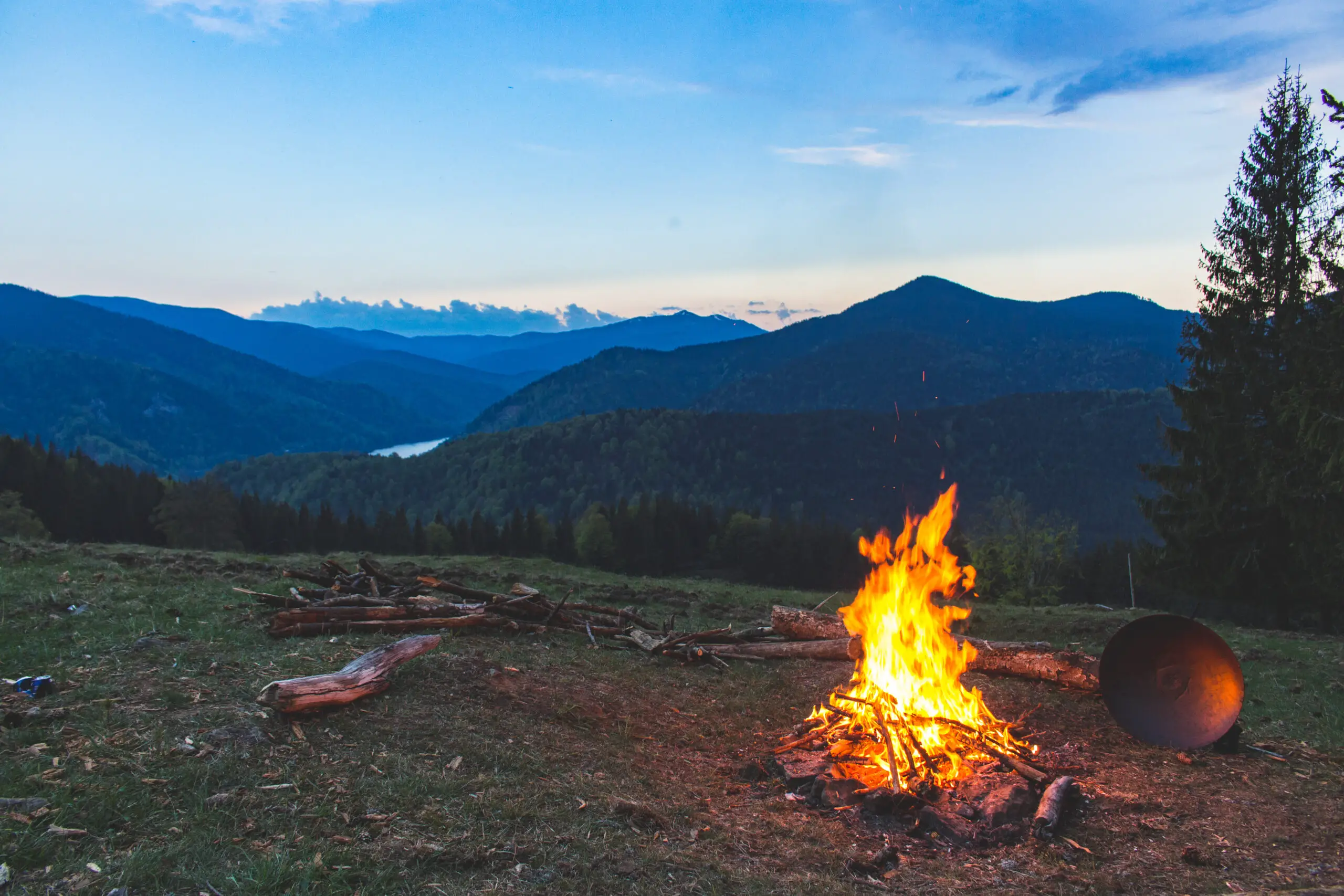 Bonfire surrounded with green grass field