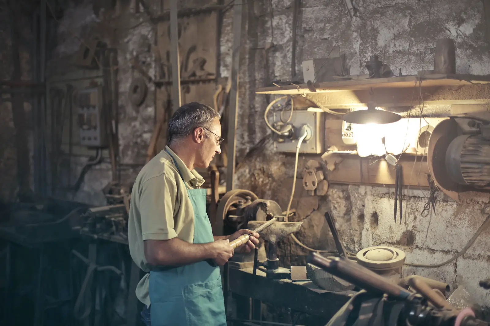 Photo of Man Standing Inside His Workshop